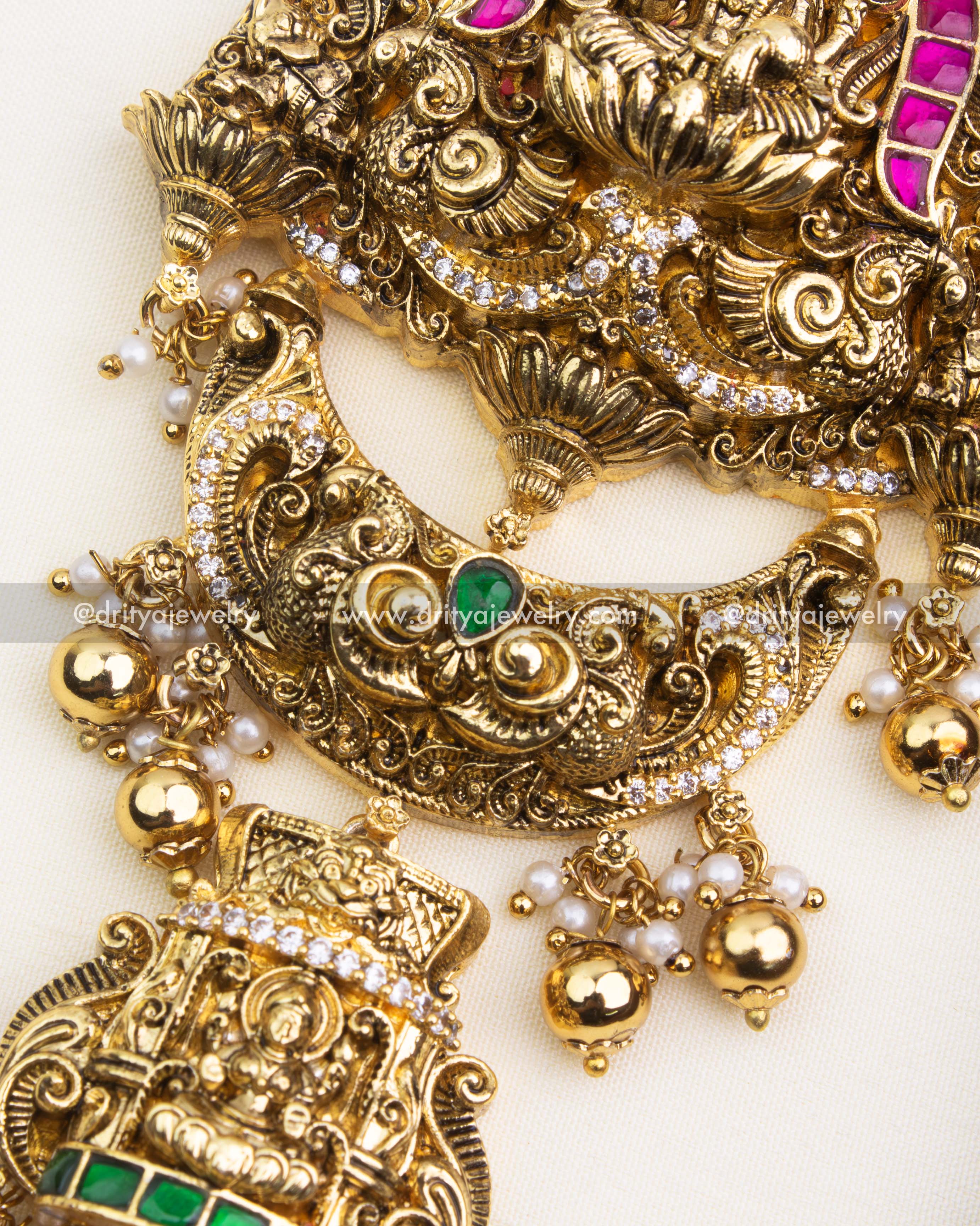 Detailed Nakshi carvings and green kemp stone embellishments on antique polished Jada Billa.