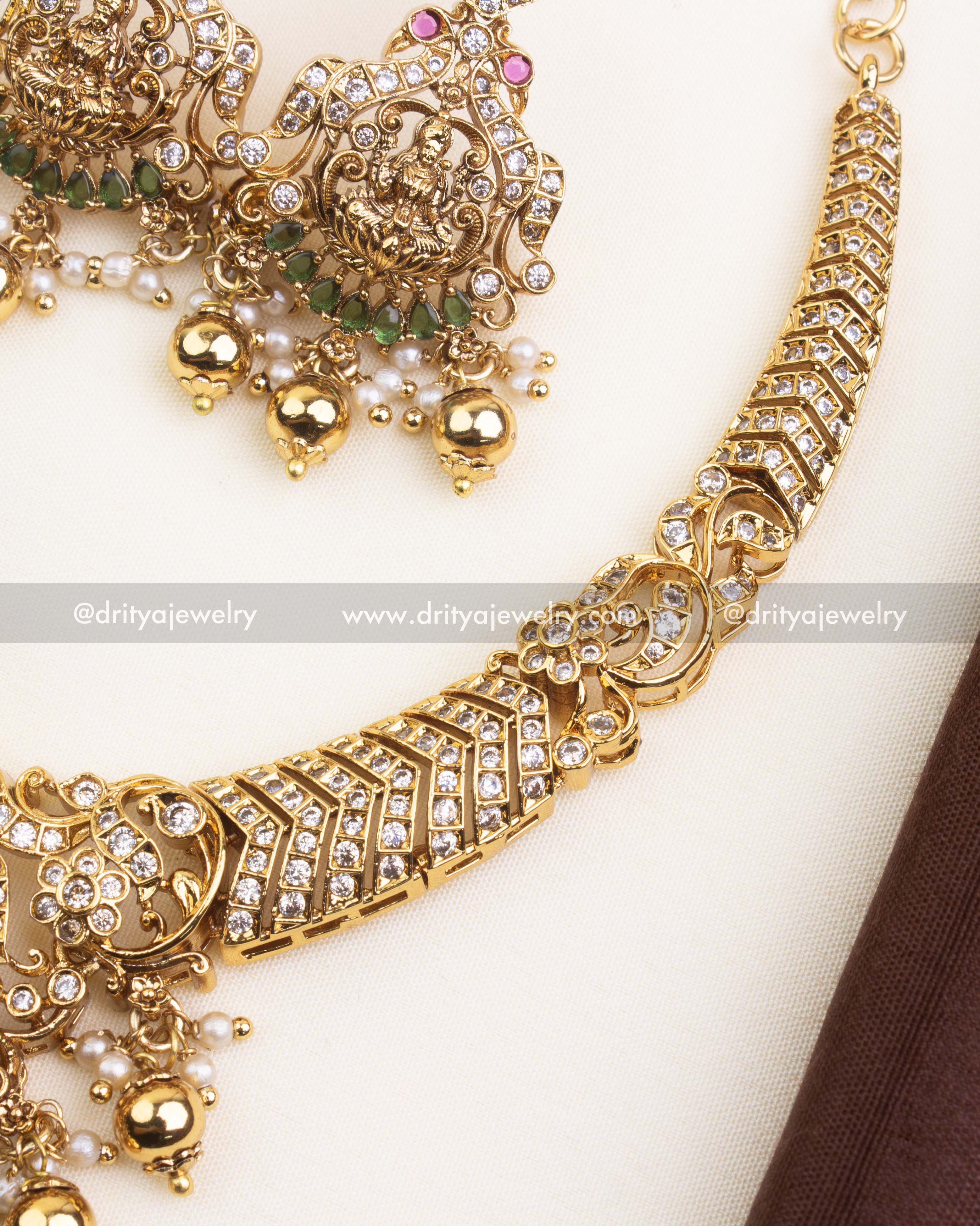 Detailed pendant view with Goddess Lakshmi motif, CZ embellishments, and green stones.