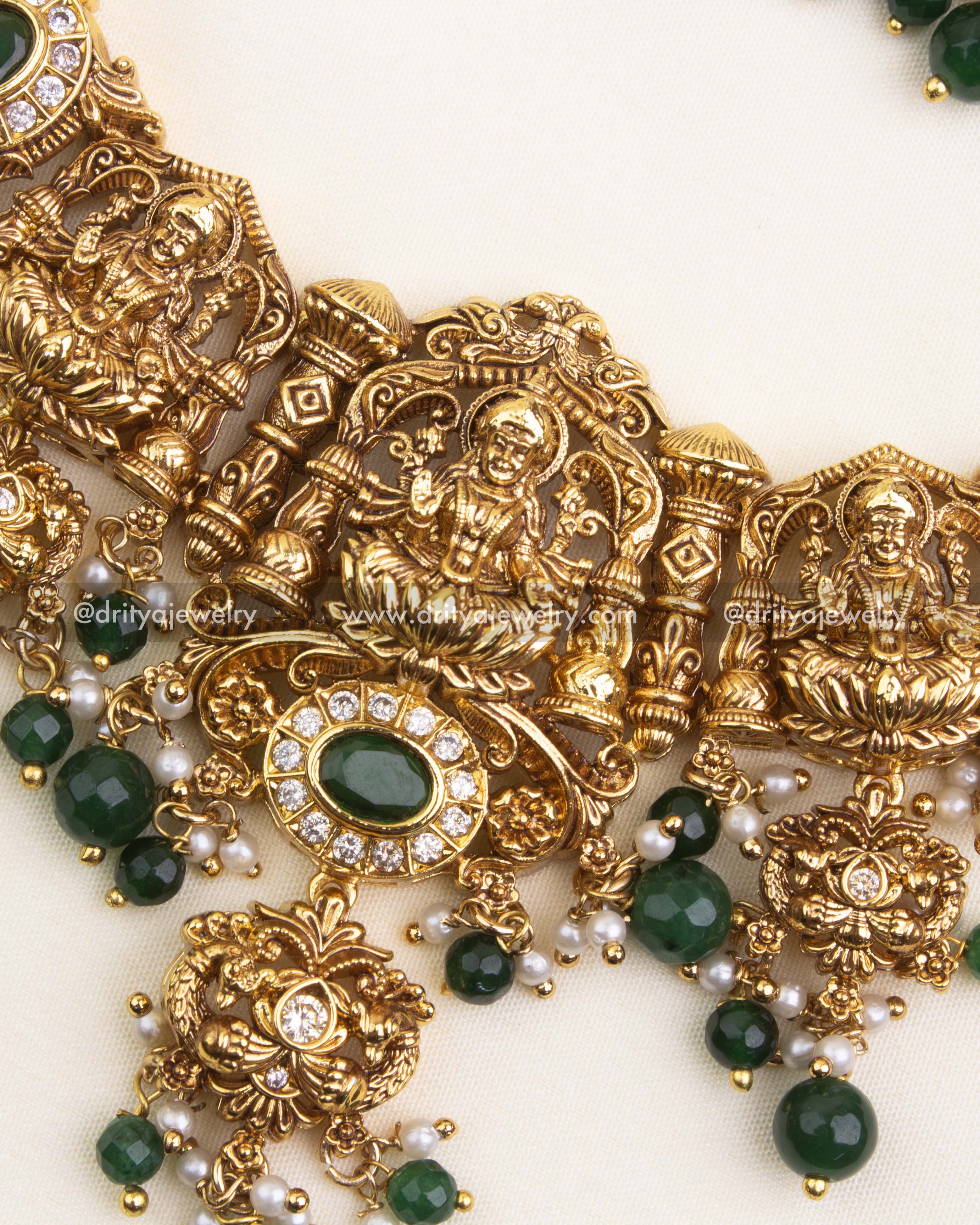 Detailed Lakshmi pendant with CZ highlights, emerald beads, and golden drops.