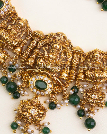 Detailed Lakshmi pendant with CZ highlights, emerald beads, and golden drops.