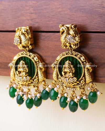 Antique gold earrings with Goddess motif and green bead work background, finished with teardrop green beads and pearls.