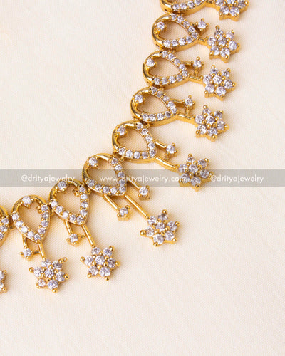 Intricate heart and floral design crafted with premium CZ stones in a gold-plated finish.