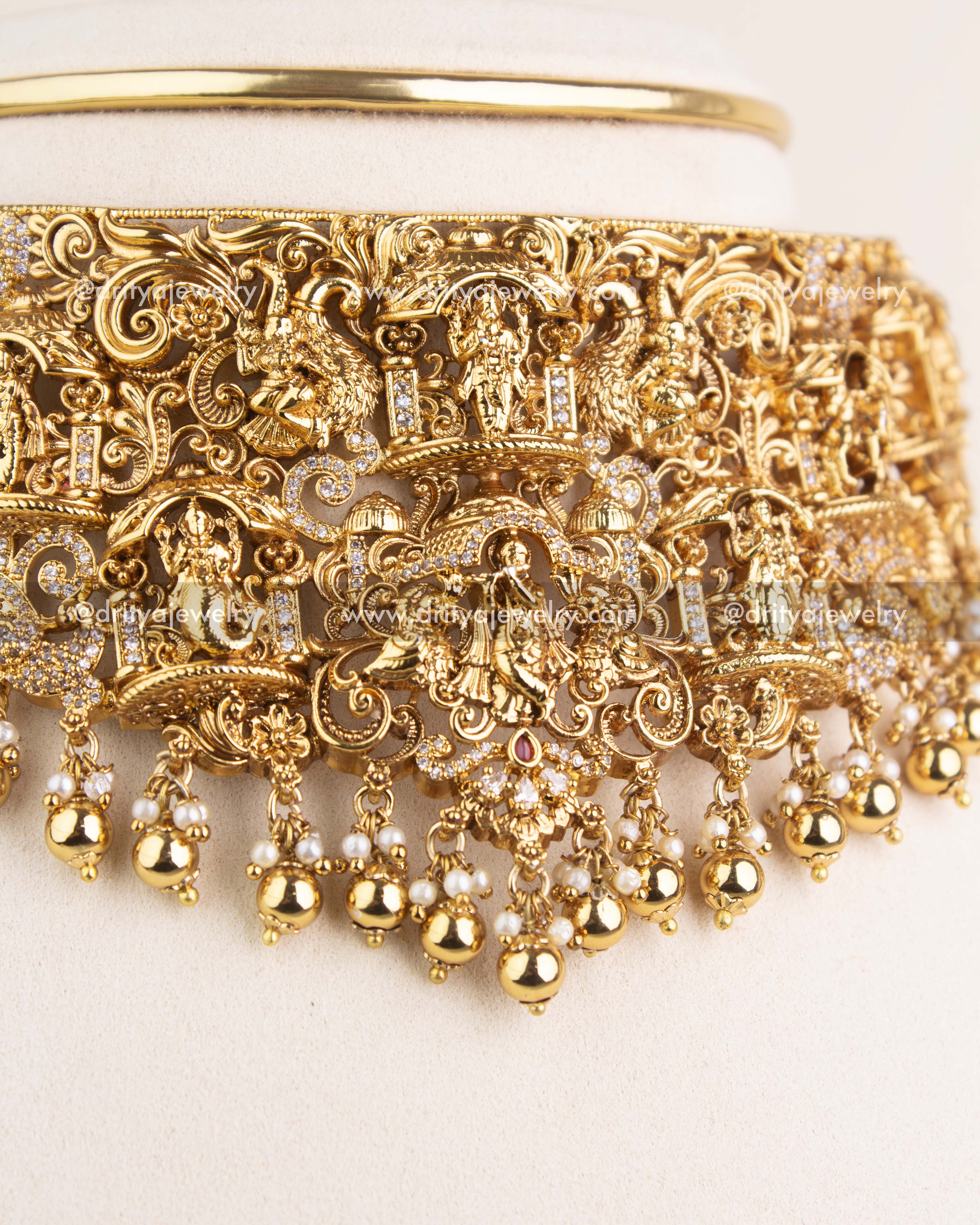 Detailed close-up of Nakshi choker with Krishna carving, temple motifs, and CZ accents.