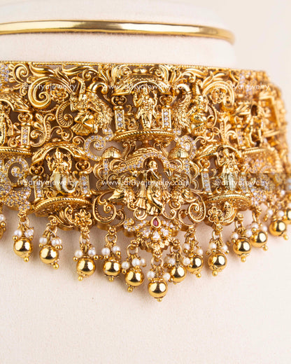 Detailed close-up of Nakshi choker with Krishna carving, temple motifs, and CZ accents.