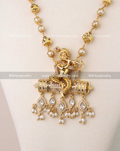 Intricate Krishna pendant design with CZ stones and dangling pearl drops.