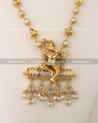 Intricate Krishna pendant design with CZ stones and dangling pearl drops.