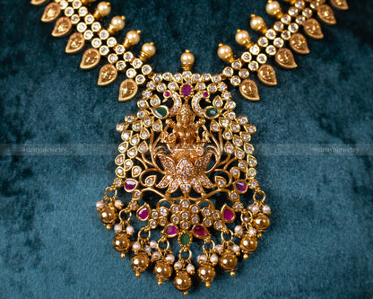 Close-up view of the Lakshmi Devi Temple Necklace Set by Dritya Jewelry, featuring intricate antique gold finish and gemstone embellishments.