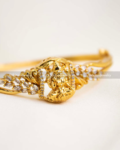 Detailed view of premium temple kada with Lakshmi idol and CZ stones in antique finish.