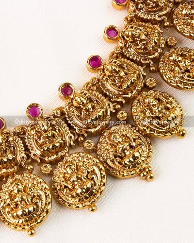 Side view highlighting coin-style Lakshmi motifs with ruby stone accents.