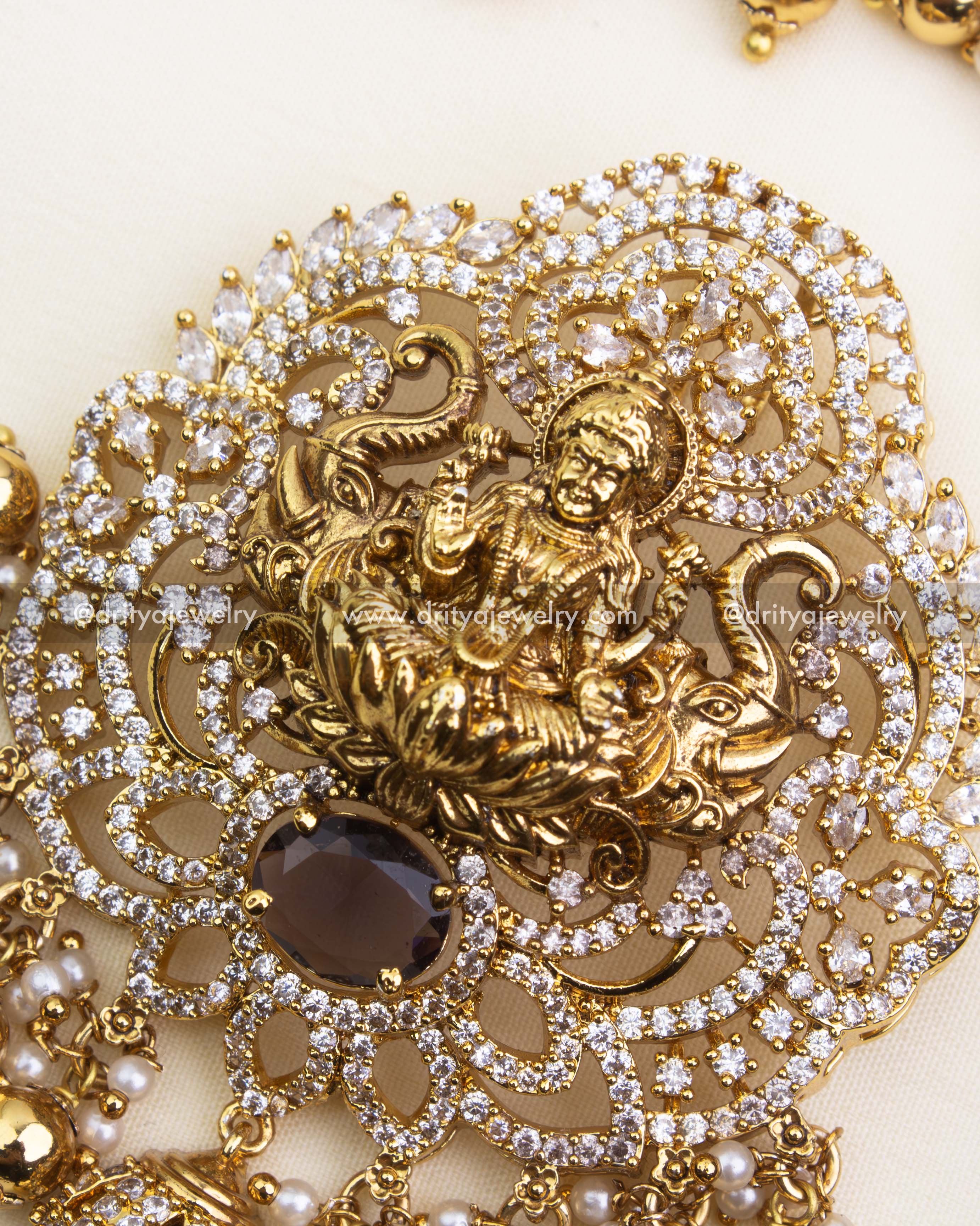Detailed Lakshmi pendant with CZ stone accents, pearls, and intricate nakshi work.