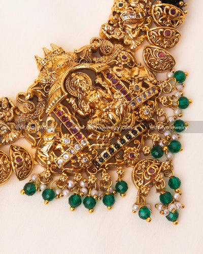 Detailed temple-inspired necklace with Nakshi engravings, green beads, and freshwater pearls.