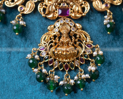 Close-up of Dritya Jewelry's Lakshmi pendant with green beads, showcasing intricate temple motifs and detailed craftsmanship.