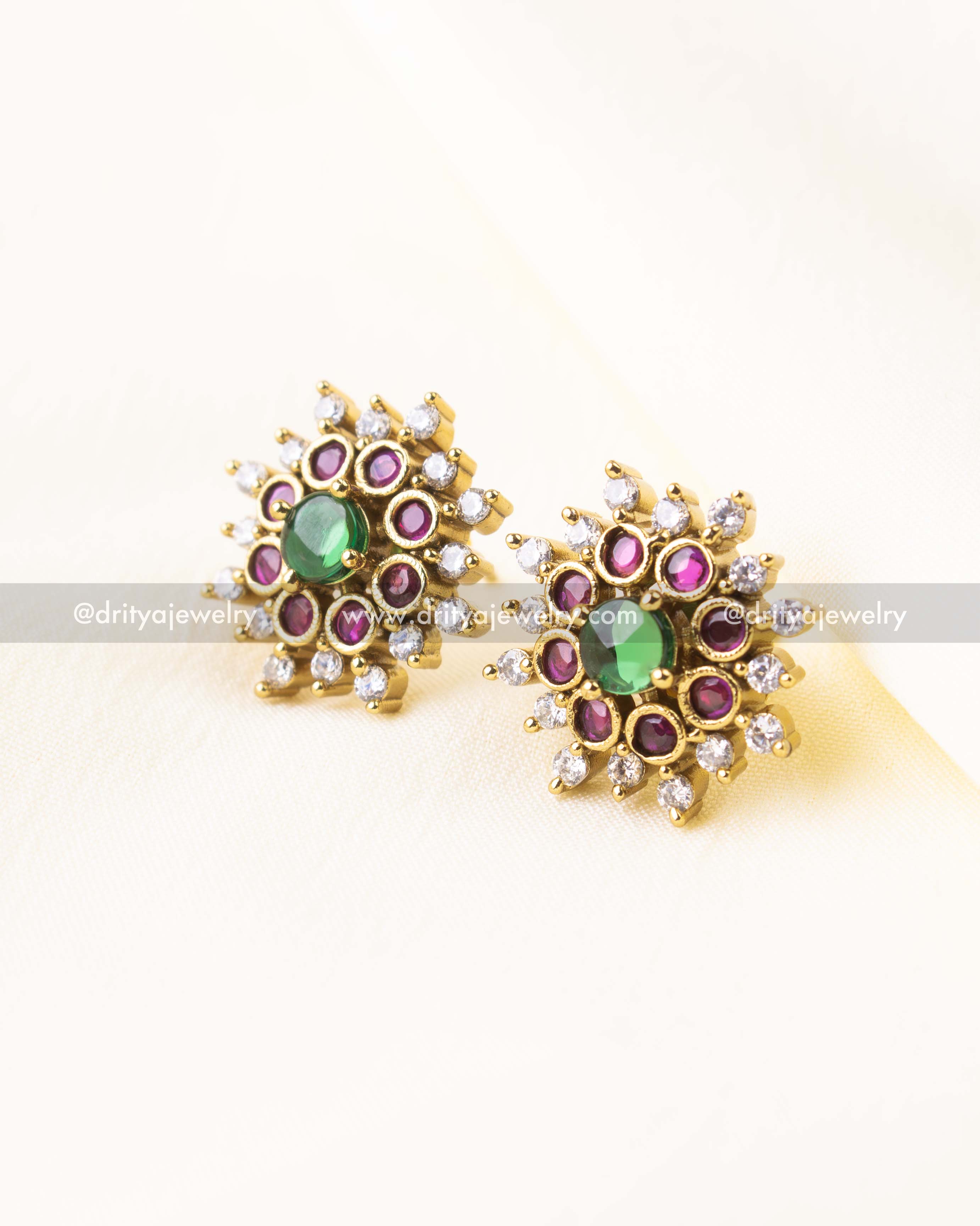 Stud earrings with green center, ruby accents, and white CZ crystals in gold polish.