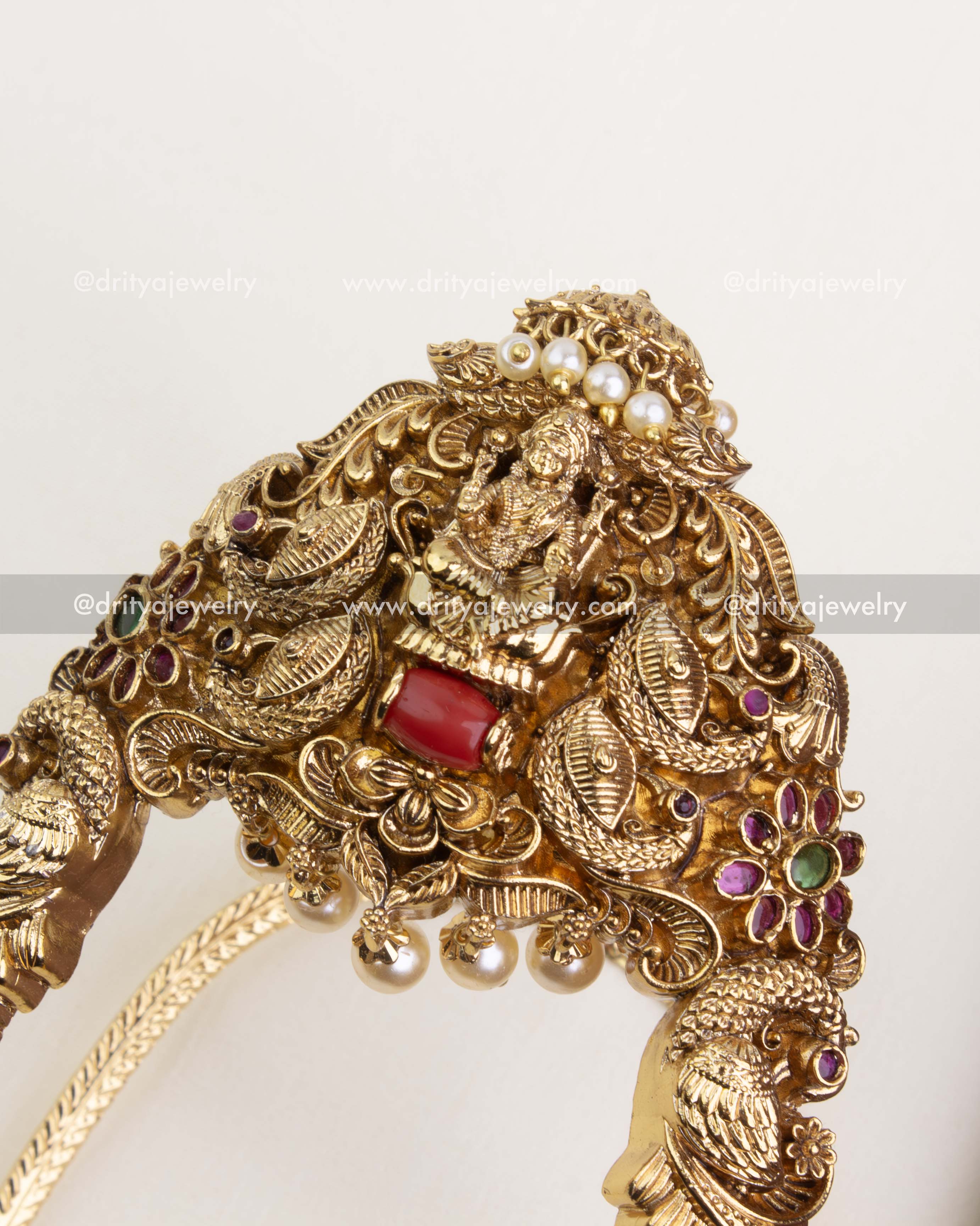 Detailed view of Lakshmi motif and floral gemstone design on temple-style aravanki.