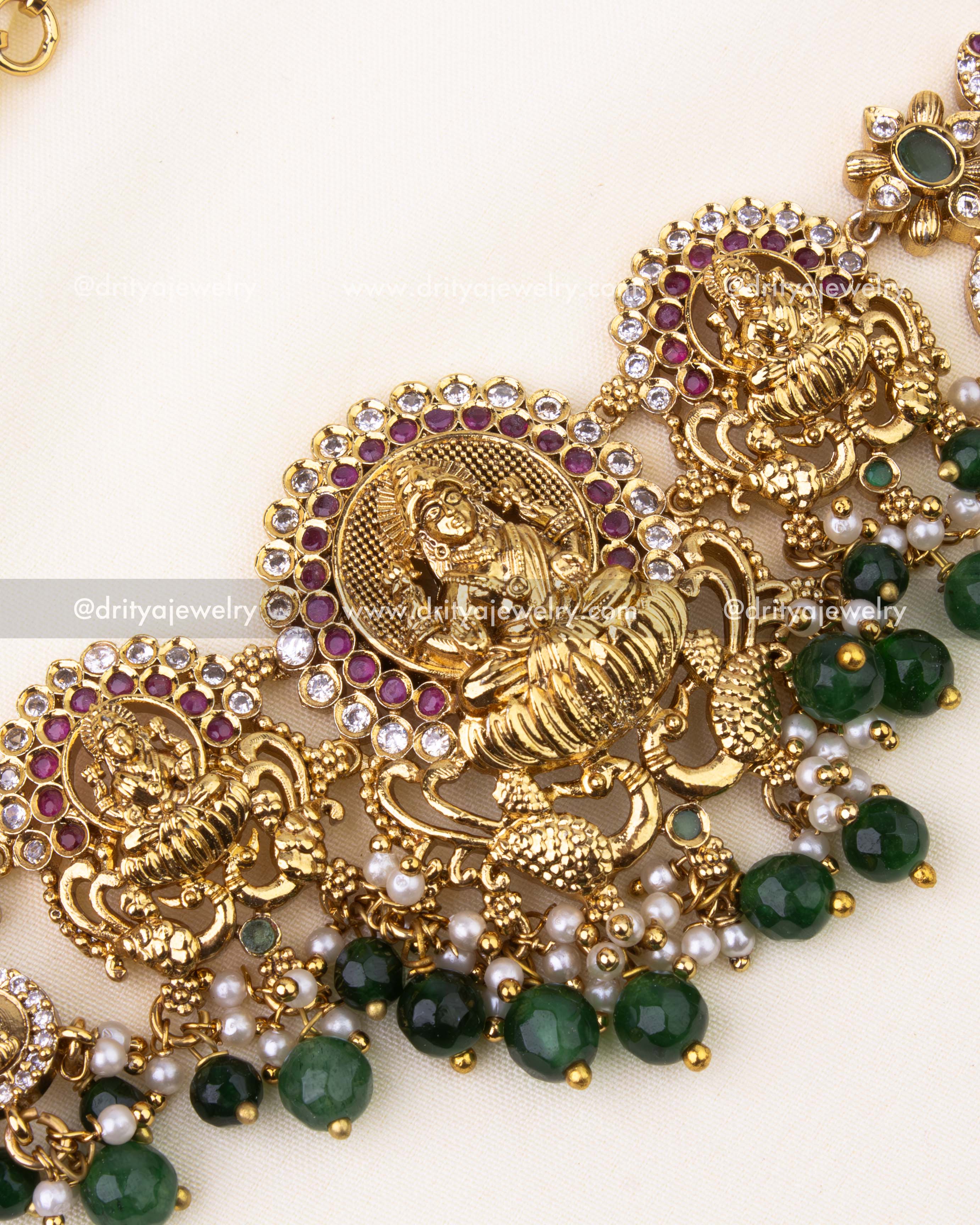 Intricate Goddess design with ruby-green stone embellishments and nakshi carvings.