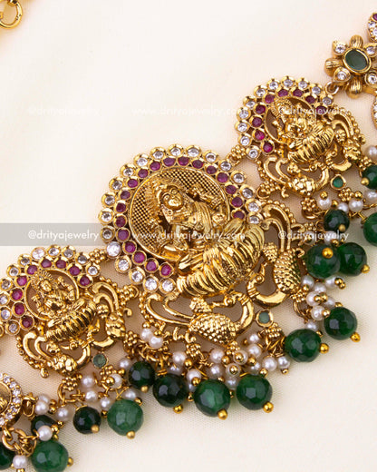 Intricate Goddess design with ruby-green stone embellishments and nakshi carvings.