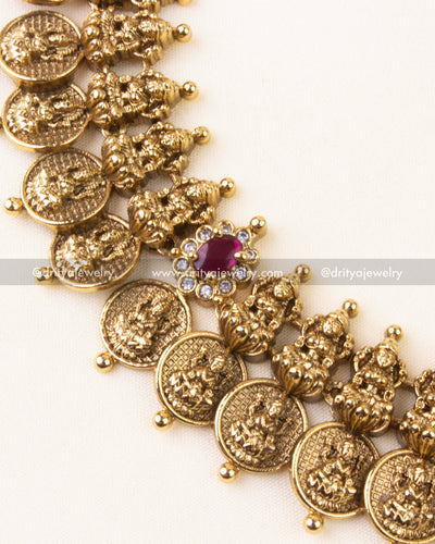 Detailed view showing embossed Lakshmi motifs and stone-studded floral connectors.