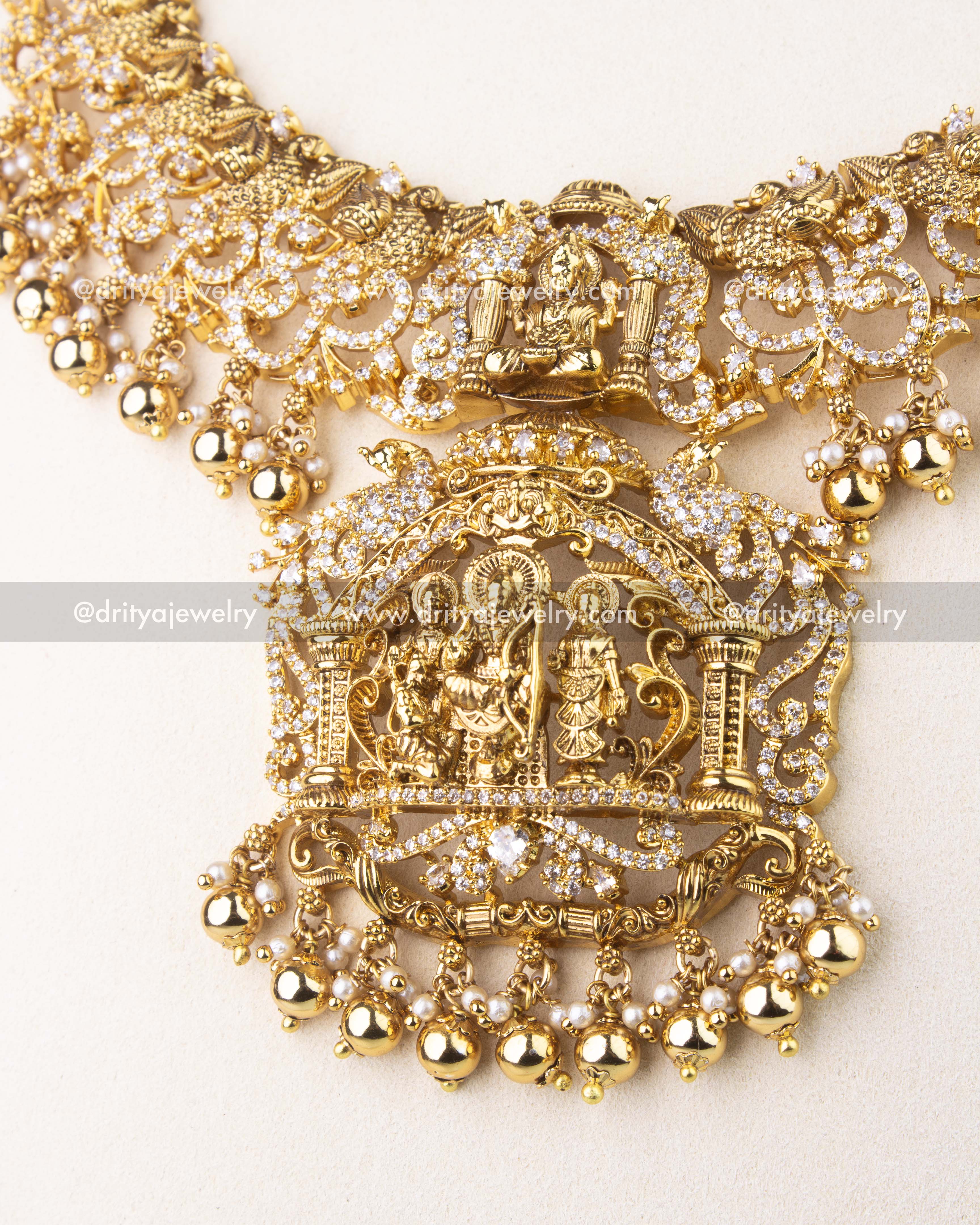 Detailed temple jewelry pendant showcasing Ram Parivar motif with pearls and intricate Nakshi carvings.