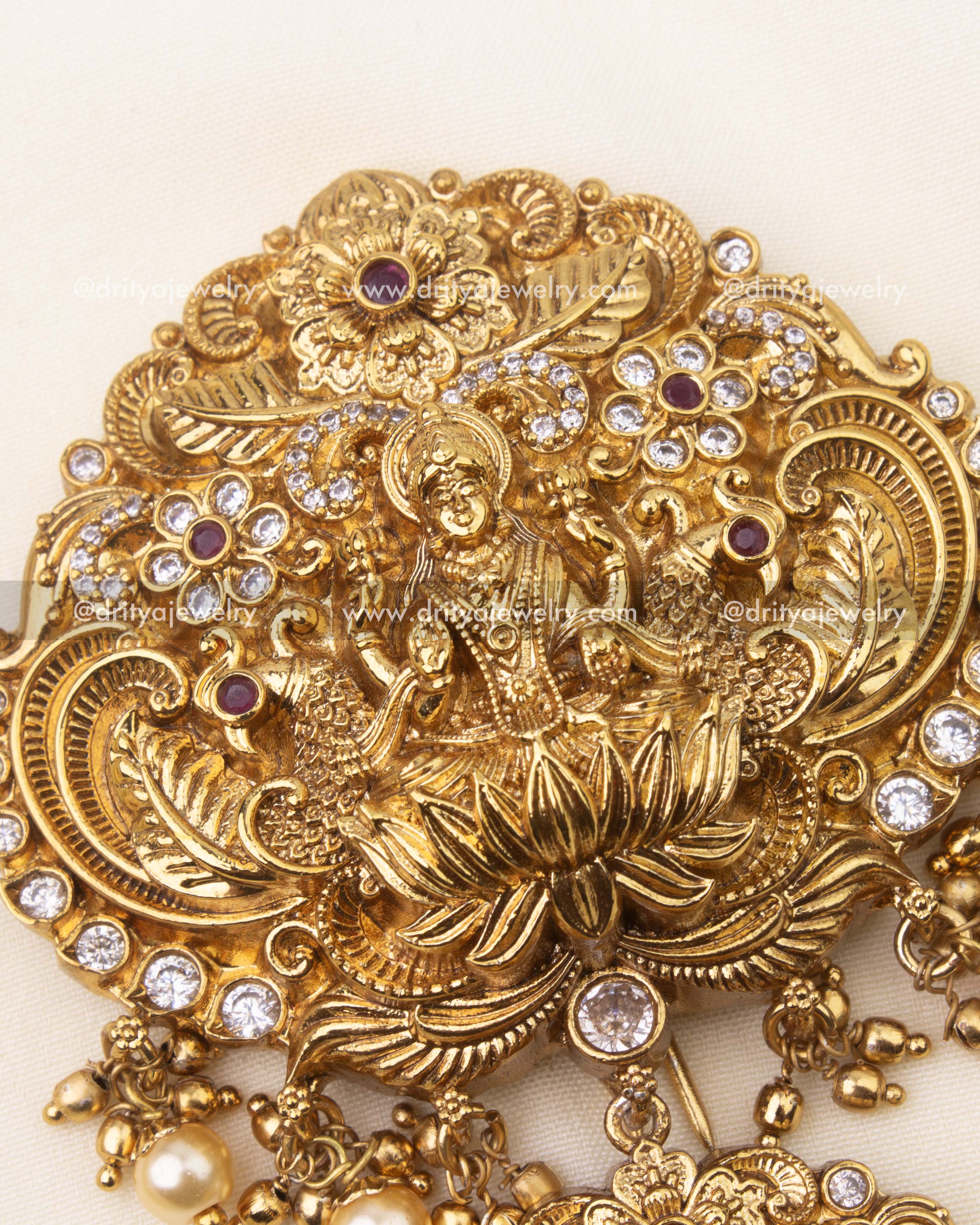Detailed close-up of Goddess motif with CZ stones and ruby accents on temple Jada Billa.