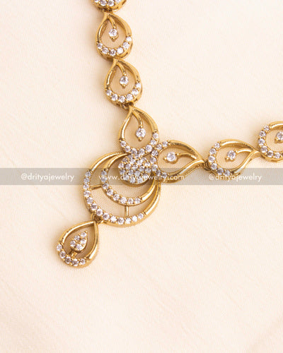 Circular CZ pendant design with tear-drop stone at center.