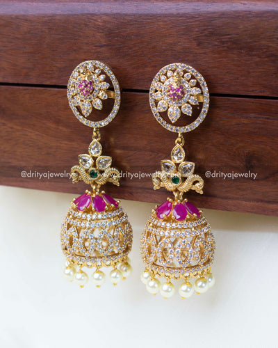 Detailed view of peacock design stud in a premium gold-plated jhumka set.