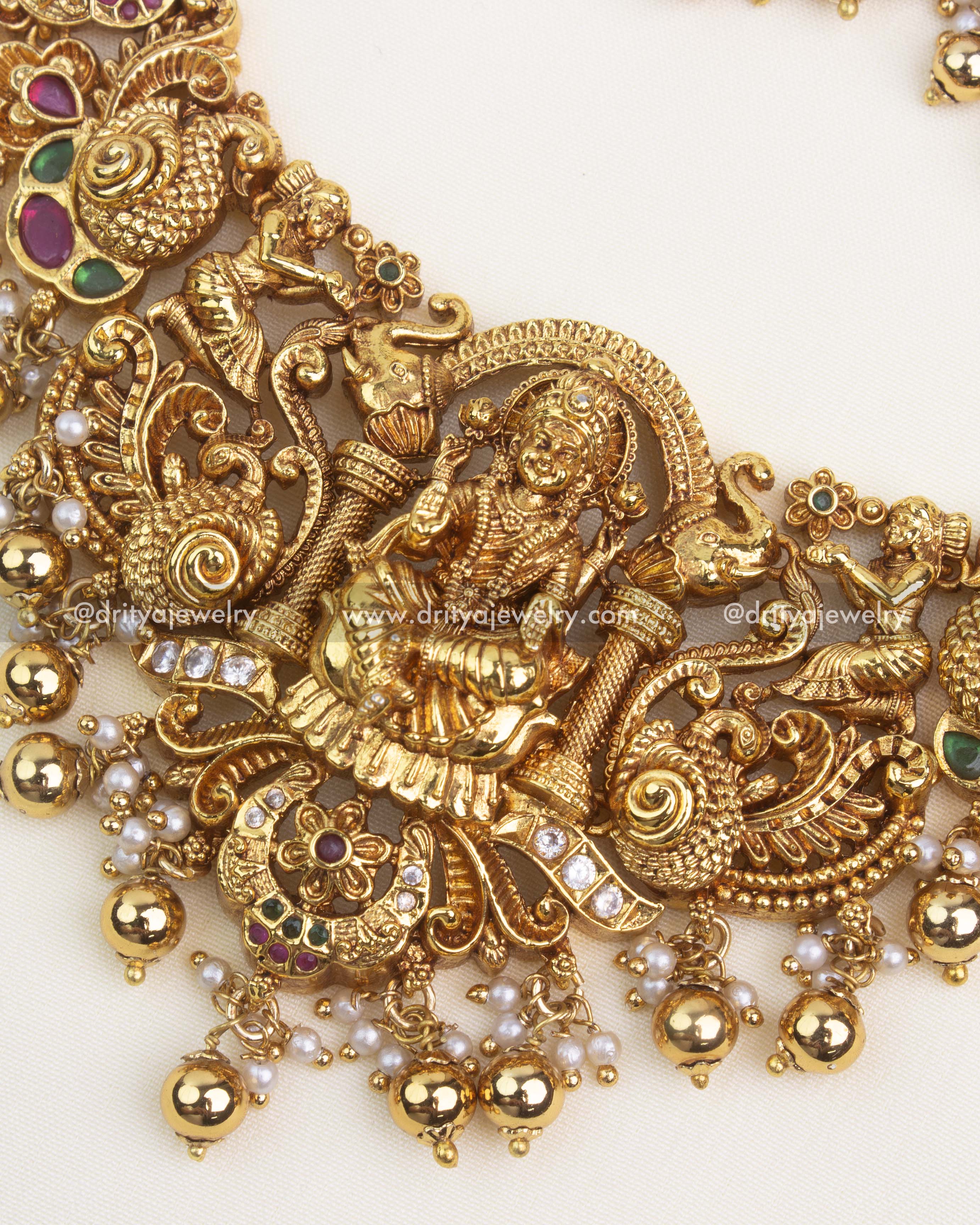 Peacock and floral Nakshi carvings with gold polish and embedded kemp stones.