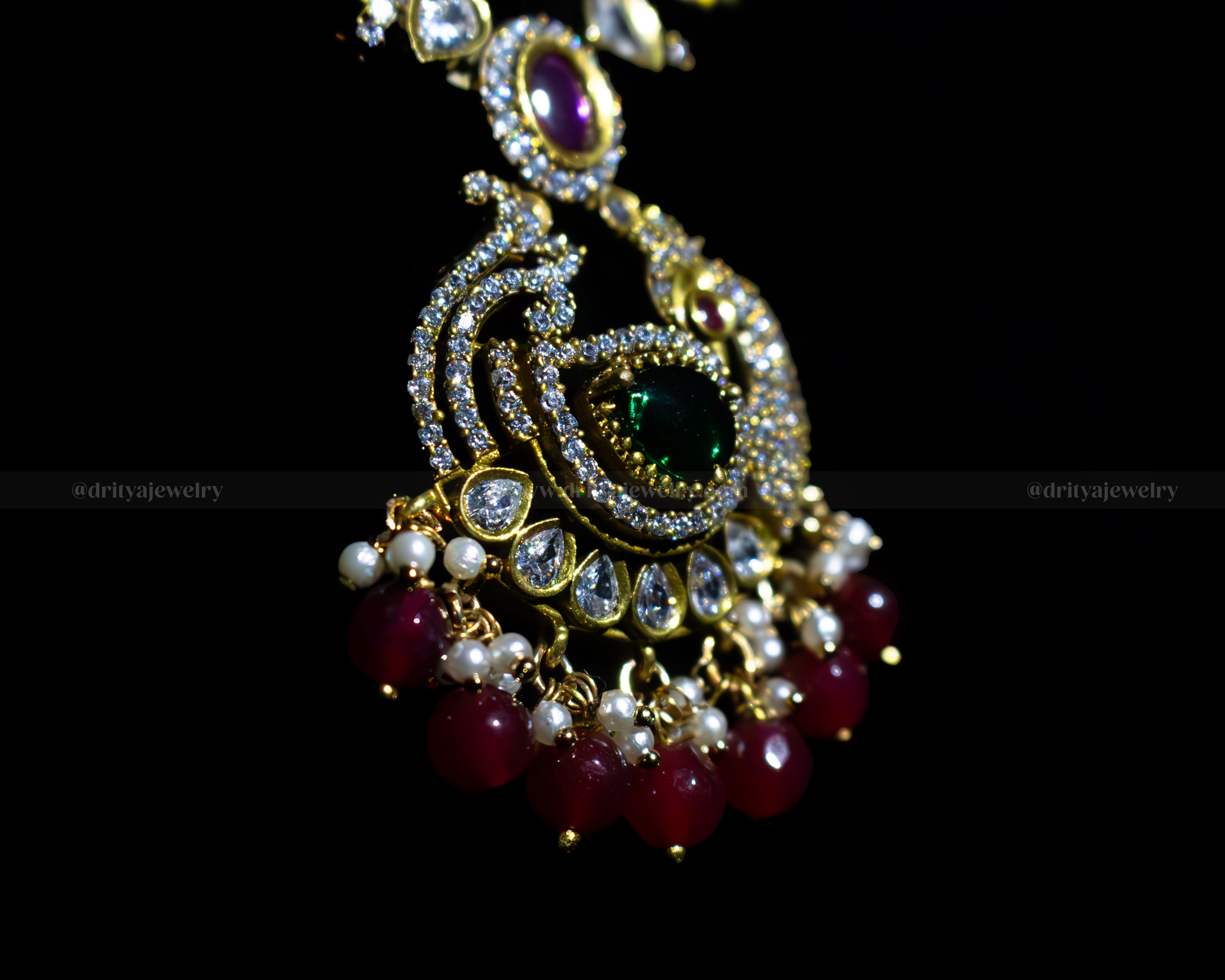 Close-up view of the ornate pendant on the Mehndi Victorian Necklace by Dritya Jewelry, showcasing emerald and ruby stones with pearl accents.