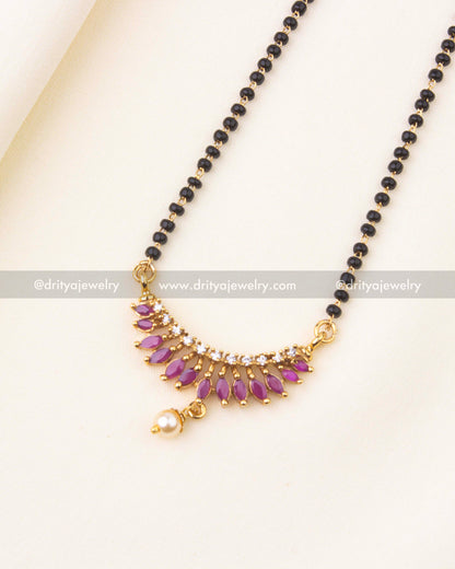 Detailed pendant with pink accents, CZ stones, and pearl drop on black beads chain.