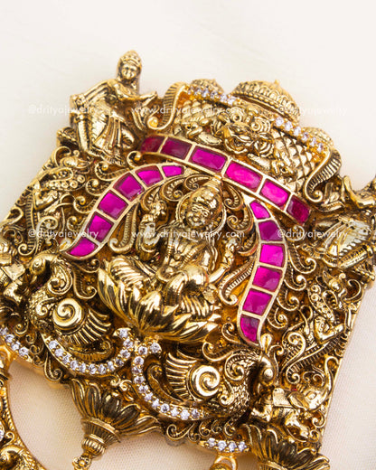 Intricate Nakshi detailing with pink stones on antique polished Jada Billa.