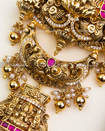Intricate Nakshi detailing with pink stones on antique polished Jada Billa.