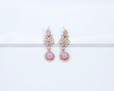 Close-up of Dritya Jewelry’s matching drop earrings from the pink stone necklace set, showcasing pink stones and CZ detailing for an elegant look.