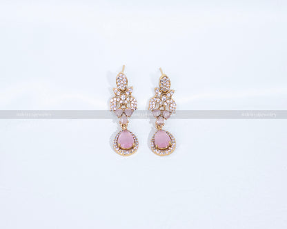 Close-up of Dritya Jewelry’s matching drop earrings from the pink stone necklace set, showcasing pink stones and CZ detailing for an elegant look.