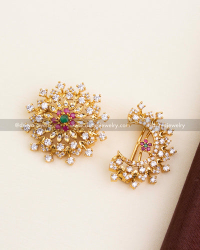 Detailed view of circular sun motif and crescent moon hair pin with sparkling CZ and gold plating.