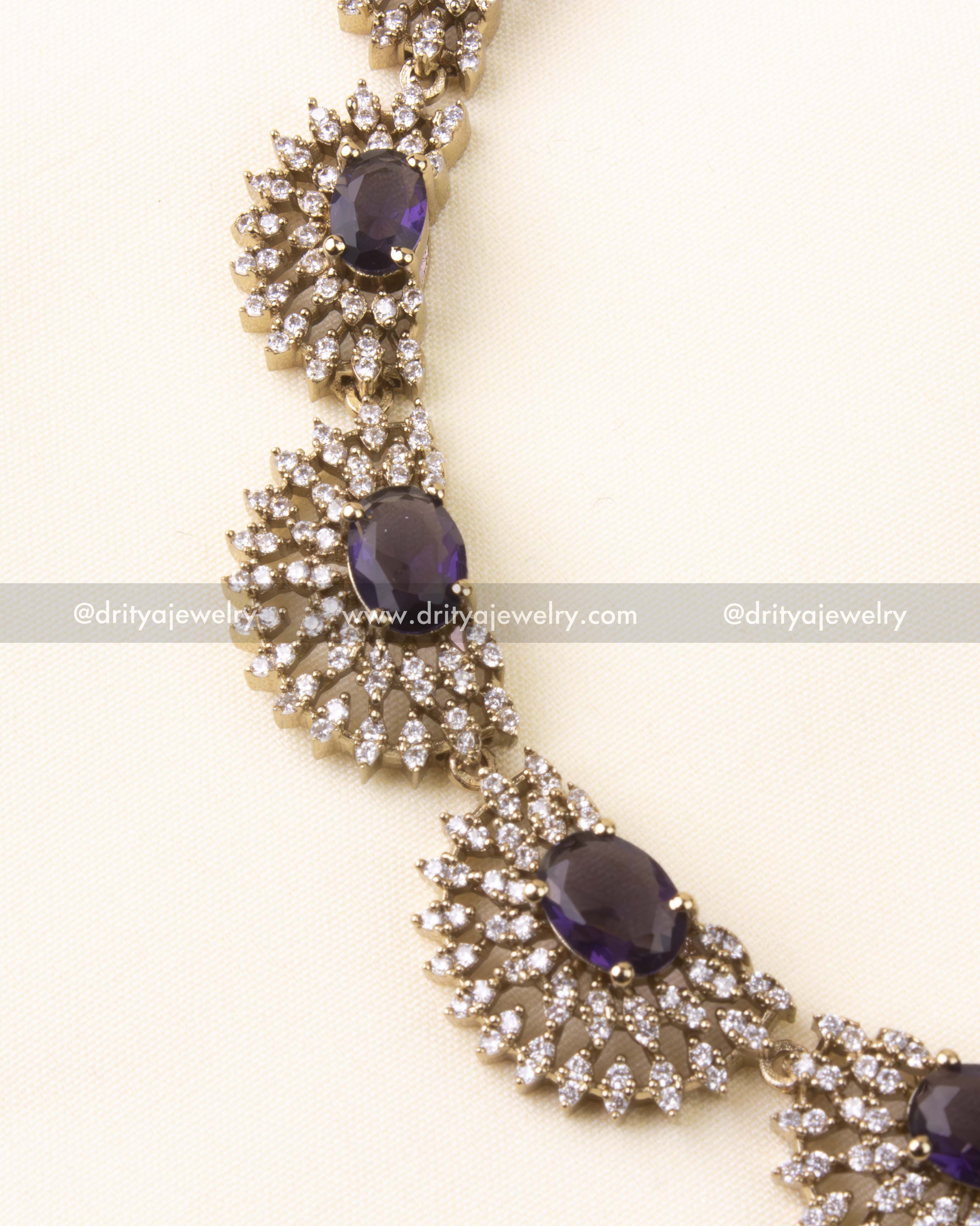 Detailed close-up of necklace segment showcasing oval purple stones and clustered CZ detailing.