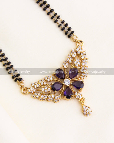 Zoomed-in image showing purple teardrop stones in a floral arrangement with CZ accents.
