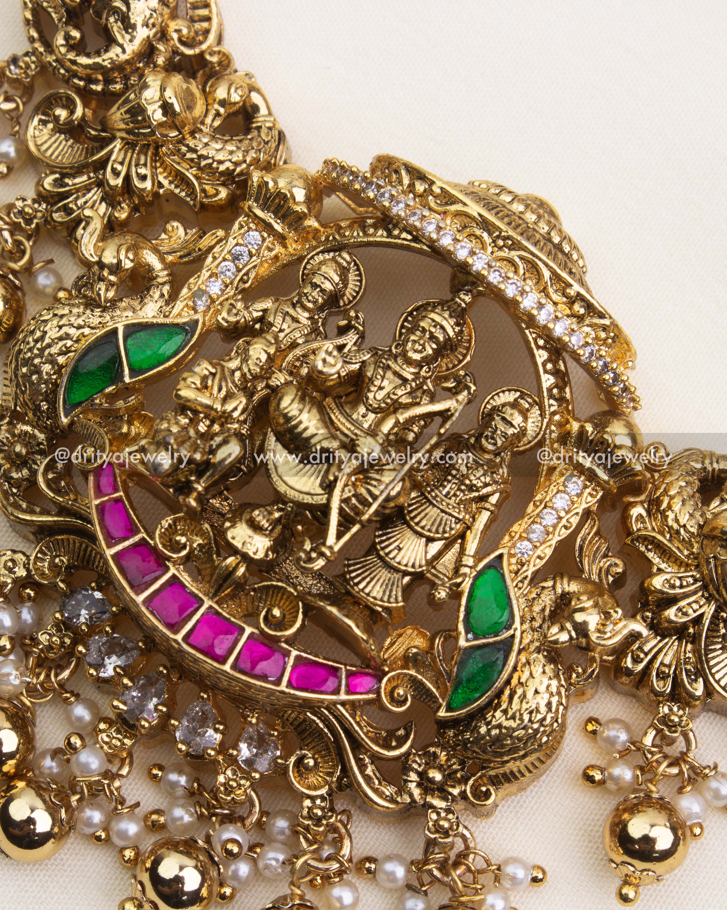 Detailed view of antique polished Ram Parivar necklace with pink and green kemp stones.