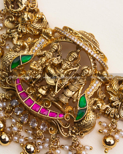 Detailed view of antique polished Ram Parivar necklace with pink and green kemp stones.