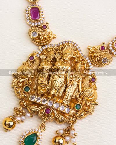 Detailed view of Ram Parivar pendant with green and ruby accents and miniature temple carvings.
