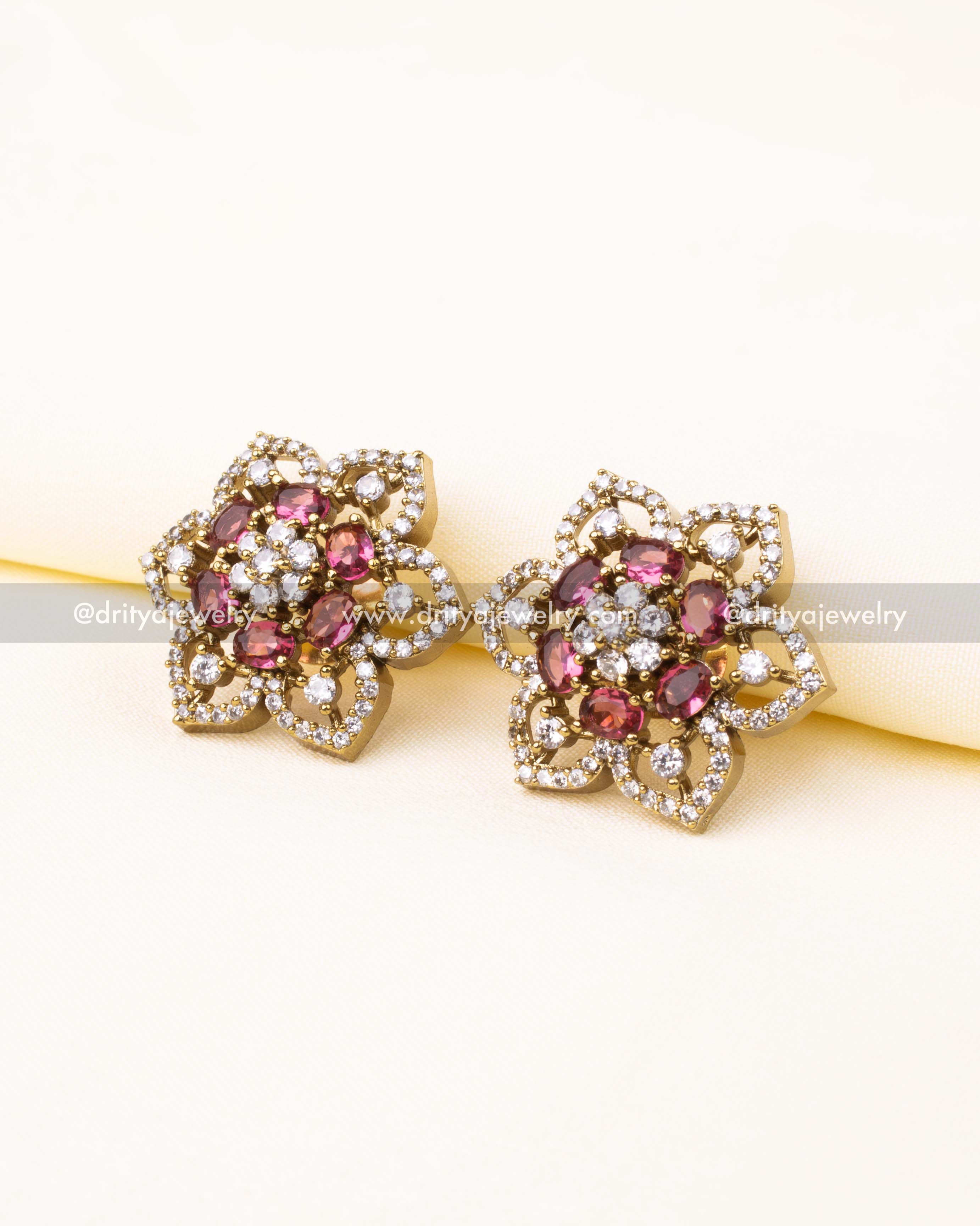 Floral CZ stud earrings with ruby red stones and antique Victorian finish.