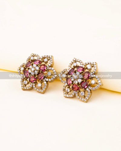 Floral CZ stud earrings with ruby red stones and antique Victorian finish.