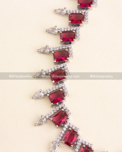 Emerald-cut red stones bordered with CZ and teardrop embellishments