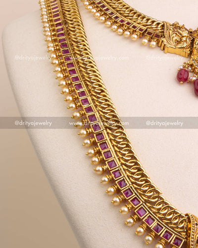 Detailed view of temple necklace chain with square-cut ruby stones and pearl edges.