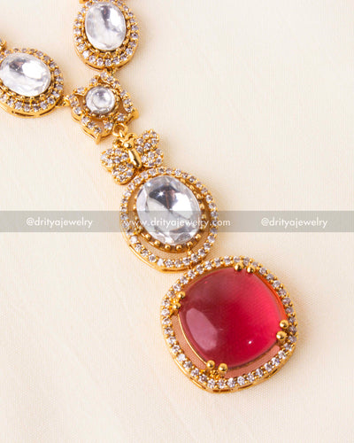 Detailed close-up of ruby red pendant with CZ-studded border.