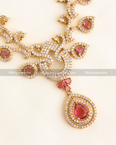 Zoomed-in view of pendant with ruby red stone and CZ-studded leaf motifs.