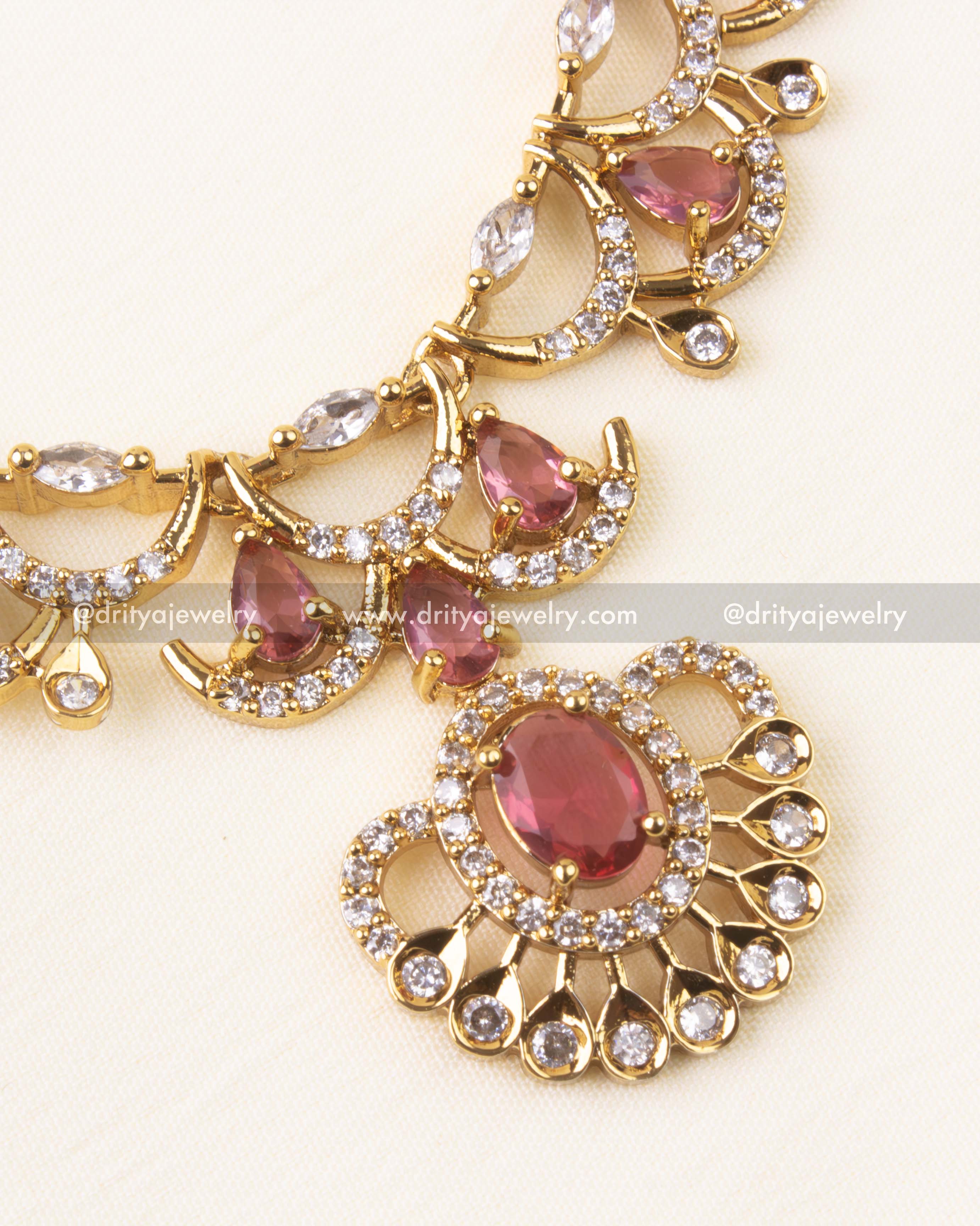 Detailed center view of ruby red stone and CZ arrangement in fixed design
