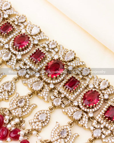 Detailed design of ruby red bridal choker with sparkling stonework.