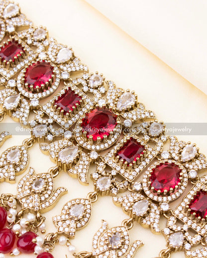 Detailed design of ruby red bridal choker with sparkling stonework.