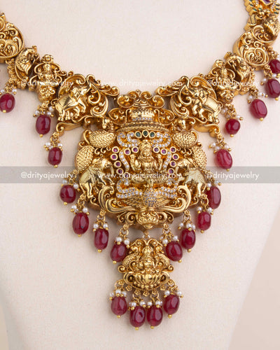 Lakshmi pendant with ruby red bead borders and multicolor CZ embellishments.