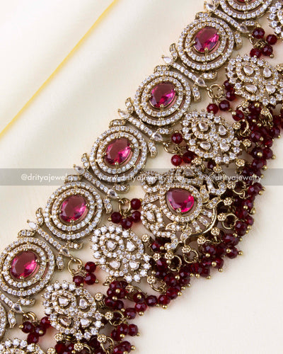 Detailed close-up showcasing ruby stones and layered red bead drops.
