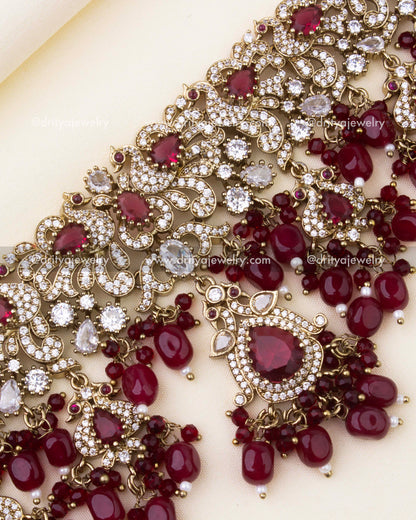 Detailed close-up of ruby red Victorian choker with CZ stones and bead clusters.